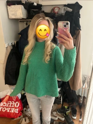 Grön ribbstickad tröja från Cubus - Mysig grön ribbstickad tröja med hög hals och långa ärmar. Från Cubus i storlek S.  Tröjan har en avslappnad passform. 