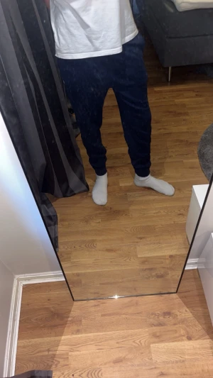 Polo Ralph lauren mjukisbyxor - Säljer ett par mörkblå polo Ralph lauren mjukisbyxor med smal passform och resår i midjan samt vid bensluten. Byxorna har en liten broderad logga på vänster lår och är tillverkade i ett mjukt och bekvämt material, perfekt för chill dagar hemma eller när du vill vara extra bekväm.