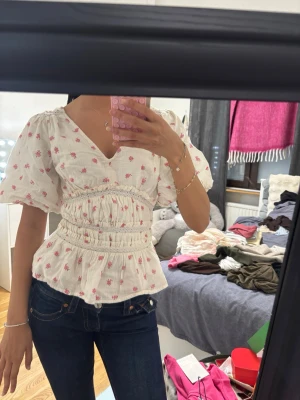Vit blus med rosa blommor  -  Fett cute men vill köpa en annan