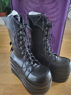 Platform boots Gururu taobao - Tall platform shoes from gururu on taobao, currently sold out. I tried them on once indoors. Bat wing, cross, stitches, buckles details. Faux leather. Condition is like new, the shoe box is damaged but I will place it inside a shipping box
