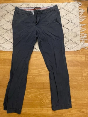 Mörkblå chinos från Jack & Jones - Snygga mörkblå chinos från Jack & Jones med klassisk rak passform och diskreta sidofickor. Tillverkade i mjukt bomullsmaterial som ger en skön känsla och stilren look. Perfekta för dig som vill ha ett par stilrena byxor till garderoben.