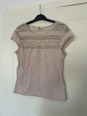 Rosa t-shirt  - Ljusrosa t-shirt med spets upptill. Lite noppig i tyget men annars bra skick.