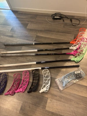Innebandyklubbor och blad mix - Säljer ett paket med fyra innebandyklubbor i olika färger och flera lösa blad i lila, rosa, svart, vitt och ljusblått. Perfekt för dig som vill byta blad eller testa olika spelstilar. Klubborna har olika färg på greppen och bladen. Säljer dessa klubbor styckpris samt bladen, så skriv till mig ifall ni är intresserade av att köpa så kompromissar vi ihop ett bra pris!