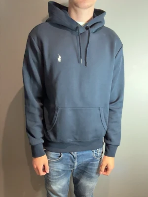 Blå Ralph Lauren Hoodie - Fint skick. Han på bild är 185cm, 77kg!
