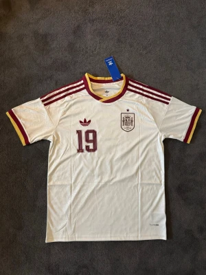 Spanien VM 26/27 borta Lamine Yamal 19 - Fotbollströja med Lamine Yamal på ryggen. Tröjan är helt ny med tagg kvar och i perfekt skick. Perfekt för dig som är supporter, samlar på fotbollströjor eller vill ha en snygg tröja till träning och vardag.                                                                      ⚪ Skickas inom 24 timmar.                                         Vid intresse eller frågor är det bara att skicka 👍