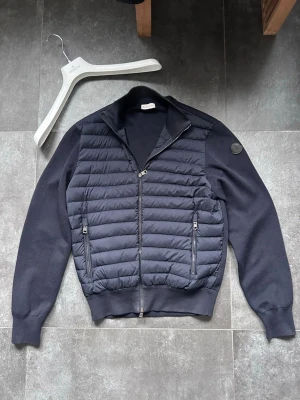 Moncler cardigan - Säljer nu denna black label moncler cardigan i topp skick.  Marinblå färg i storlek M.  En moncler galge medföljer. Bedöm skick själv utifrån bilderna.