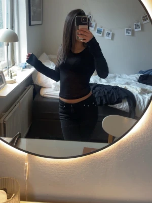 Svart långärmad topp från Nelly - Säljer en svart, tight långärmad topp från Nelly. Toppen är tunn och något genomskinlig passar perfekt för fest å Valborg 