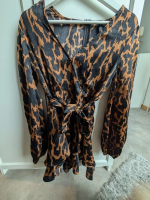 Jumpsuit  - Jumpsuit med knyte i midjan. Fint skick storlek 36