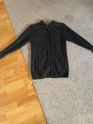 Mörkgrå stickad cardigan tröja - Säljer nu min riktigt snygga cardigan tröja, nästan helt ny utan defekter, nypris är ungefär runt 900, priset går att diskutera