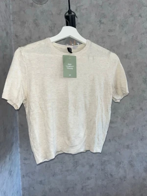 Beige kortärmad topp från H&M - En enkel och stilren beige topp från H&M med rund halsringning och korta ärmar. Helt ny och oanvänd🤍