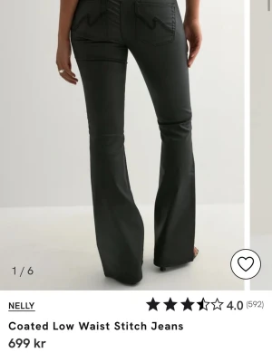 Svarta coated low waist jeans Nelly - Snygga svarta ”skinn” jeans från Nelly med låg midja och utsvängda ben. Jeansen har markerade sömmar både fram och bak. Perfekta för dig som vill ha ett par trendiga och bekväma jeans med extra attityd. Använda 1-2 gånger. Tveka inte vid frågor🥰