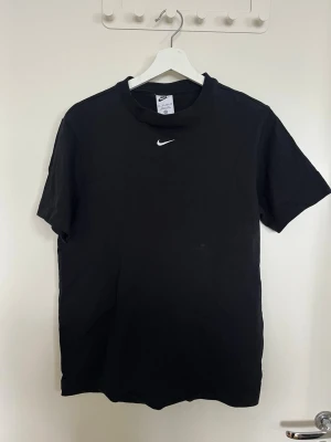 Nike essential T-shirt - Säljer min svarta Nike t-shirt i en oversized modell med en broderat logga på bröstet. Så snygg och stilren och en perfekt basic t-shirt.  T-shirten är endast använd vid ett tillfälle, så den är nästan i nyskick utan några tecken på användning. 🖤