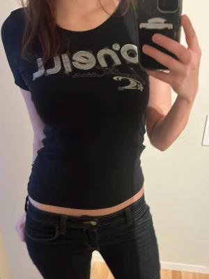 Svart O'Neill t-shirt med tryck - Snygg svart t-shirt från O'Neill med silverfärgat tryck. Modellen är figurnära med korta ärmar och rund halsringning.