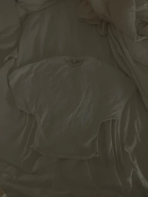 Vit basic t-shirt med tjat midja från Nelly - En klassisk vit t-shirt från Nelly med rund hals och korta ärmar. Tillverkad i mjuk bomull för en skön och avslappnad känsla. Perfekt att matcha med jeans eller shorts för en enkel och stilren look.