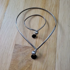 Vintage breclet and necklace set - Silver plated & black onyx. I believe it is from the 60s but I cannot promise that's the correct year. It is definitely vintage. Very minor signs of wear, mostly on the underside where it is not visible anyways. The braclet has a tighter clasp and needs to be pulled open before putting on your wrist. Choker necklace opens wide. Bundle discounts: two items 5% off (automatic) three items 10% off, five items 20% off. Message me before purchasing 3+ items for discount.