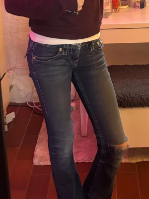 Blå True Religion jeans 💞 - Säljer ett par jättesnygga blå jeans från True Religion med lite slitningar och ett hål vid knät. 💞