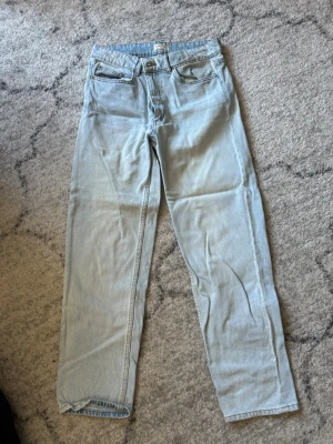 Ljusblå raka jeans från Lindex - Säljer ett par ljusblå jeans från Lindex i rak modell. Klassisk femficksdesign och normal midja. Jeansen är tillverkade i denim och har en avslappnad passform som passar perfekt till en trendig vardagslook.