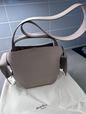 Acne studios  Musubi Midi Tote Taupe  - Säljer en helt ny  stilren beige handväska från Acne Studios i slätt läder. Ny pris 16500 kr  kvitto kan skickas 