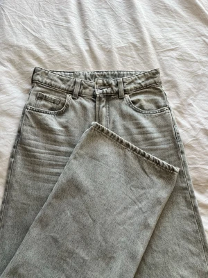 Grå raka jeans med hög midja - Säljer ett par grå jeans med rak passform och hög midja. Klassisk femficksmodell