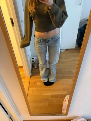 Ljusblå bootcut jeans från weekday - Säljer ett par ljusblå bootcut jeans med låg midja och klassisk femficksdesign. Jeansen har en avslappnad passform och är perfekta för en trendig vardagslook. Materialet är denim i bomull och de har en snygg tvättad finish. Jeansen har lite fläckar men dom syns knappast❤️❤️