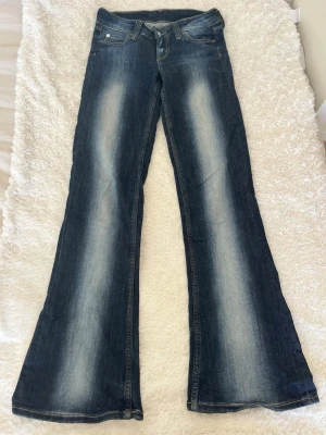 Trendiga jeans från Weekday Cheap Monday - Superfina mörkblå jeans med vita slitningar från Weekday Cheap Monday!! Lite slitna längst ner på byxorna men inget man märker av🩵🩵vet tyvärr inte storlek men skulle säga att de passar som en s