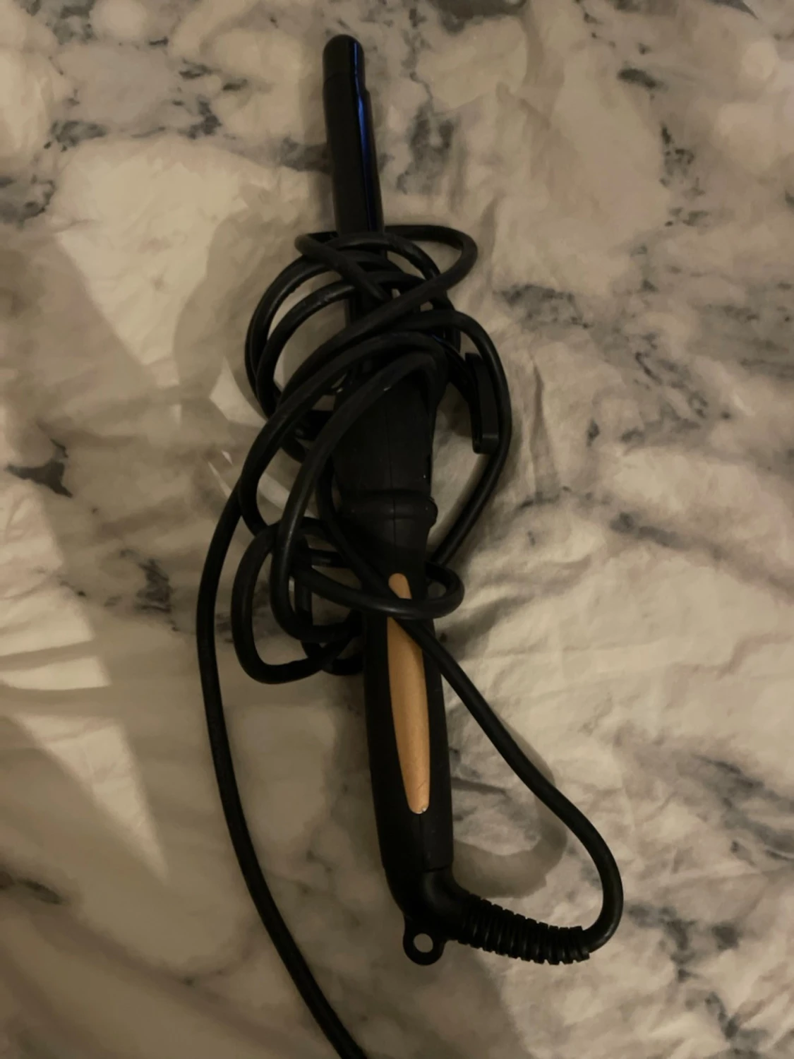 Svart locktång med beige detalj