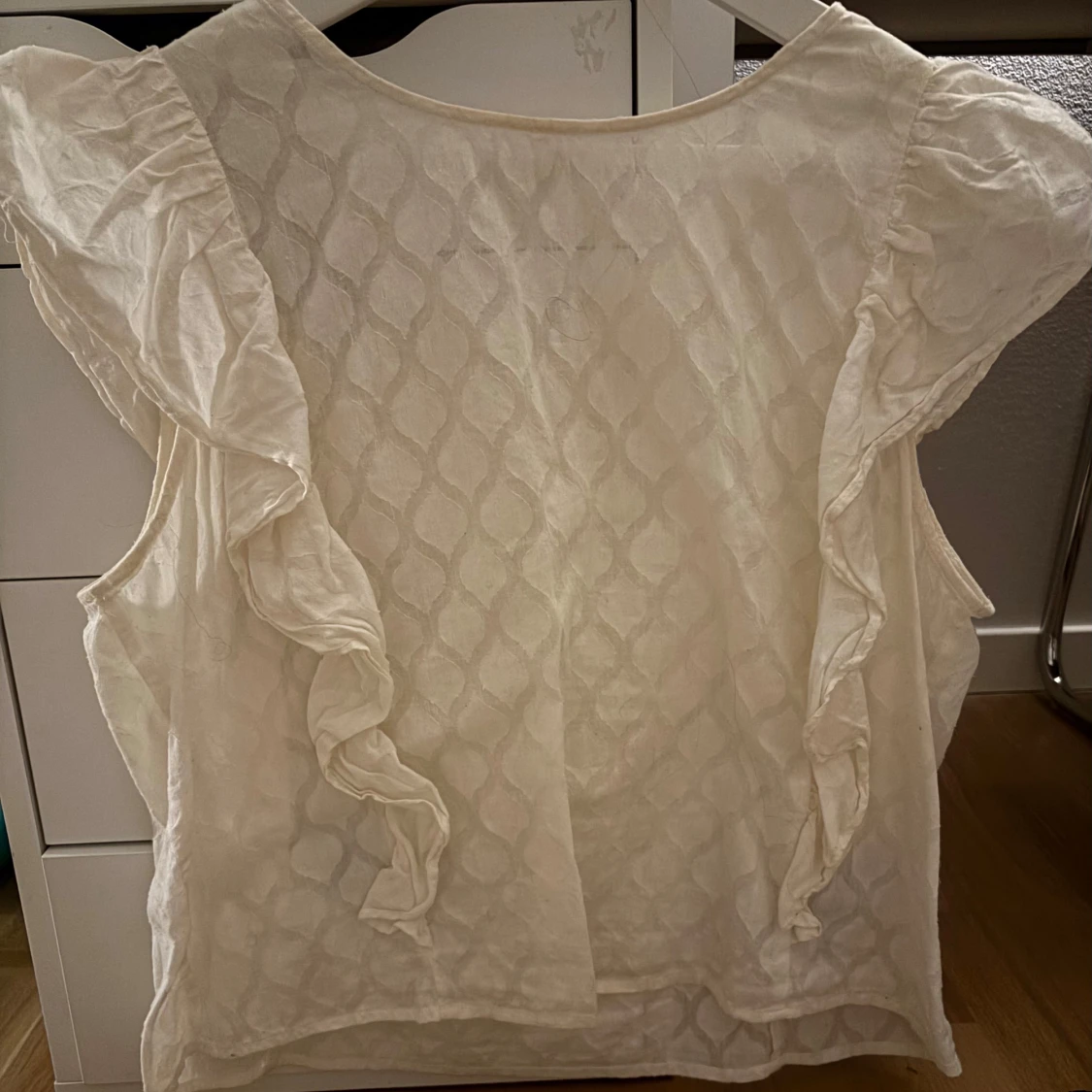 Vit blus med volangdetaljer