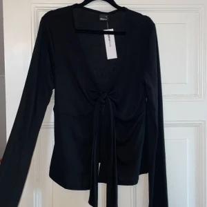 Populär svart topp gina - Säljer denna populära toppen från Gina! Aldrig använd, storlek XL men passar även L