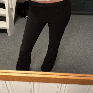 Svarta kostymbyxor från Gina Tricot - Svarta byxor från Gina Tricot storlek L. Jag brukar ofta ha S eller 38 på byxor så dessa byxor passar för dom som har de också. Dom kan bli lita för lösa i midjan men då är de bara och vika ner dom så passar dom💓(lite noppriga)