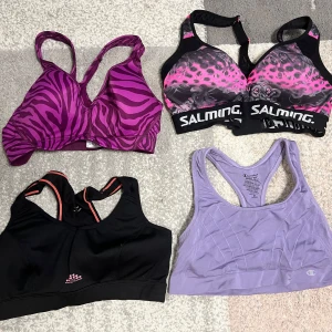 Fyra sportbehåar i olika färger och mönster - Säljer fyra sportbehåar i olika stilar. En rosa med zebramönster, en svart och rosa från Salming med leopardmönster, en svart med orange detaljer och en ljuslila från Champion. Perfekta för träning och bekväma att bära. En för 30kr eller alla fyra för 100kr. Ingen av dem är använda