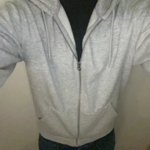 Grå hoodie från Weekday - Säljer en stilren grå zip hoodie från weekday i storlek Xs/S nypris 500kr säljer för 249kr, pris kan diskuteras vid snabb affär. Skicket är utmärkt endast använd några gånger inga teceken på defekter 9/10. Modellen är 185, passar folk som är allt mellan 175-190 skulle jag säga. Hör av er om ni har frågor.