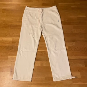 Vita mjukisbyxor från Polo Ralph Lauren - Ett par vita mjukisbyxor från Ralph lauren som är använda en gång. De har öppen benöppning som kan ändras som man vill. Säljs inte längre med öppen benöppning, så passa på;)