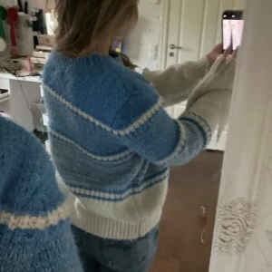 Blå och vit stickad tröja - Mysig stickad tröja i blått och vitt med randigt mönster. Perfekt för kyliga dagar med sin varma och bekväma passform. Tröjan har långa ärmar och ribbade kanter vid ärmslut och nederkant. Perfekt för höst och vinter! Nypris är 500kr