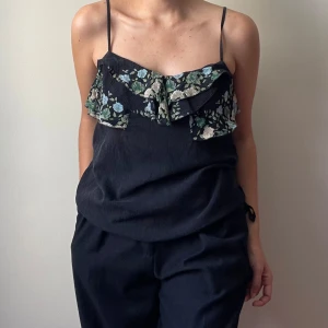 Free People Cotton Tank Cami - Washed Black Cotton Tank Top with Floral Print Layered Ruffles and a Drawstring at the Hem  Best Fits Size S/M  100% Cotton