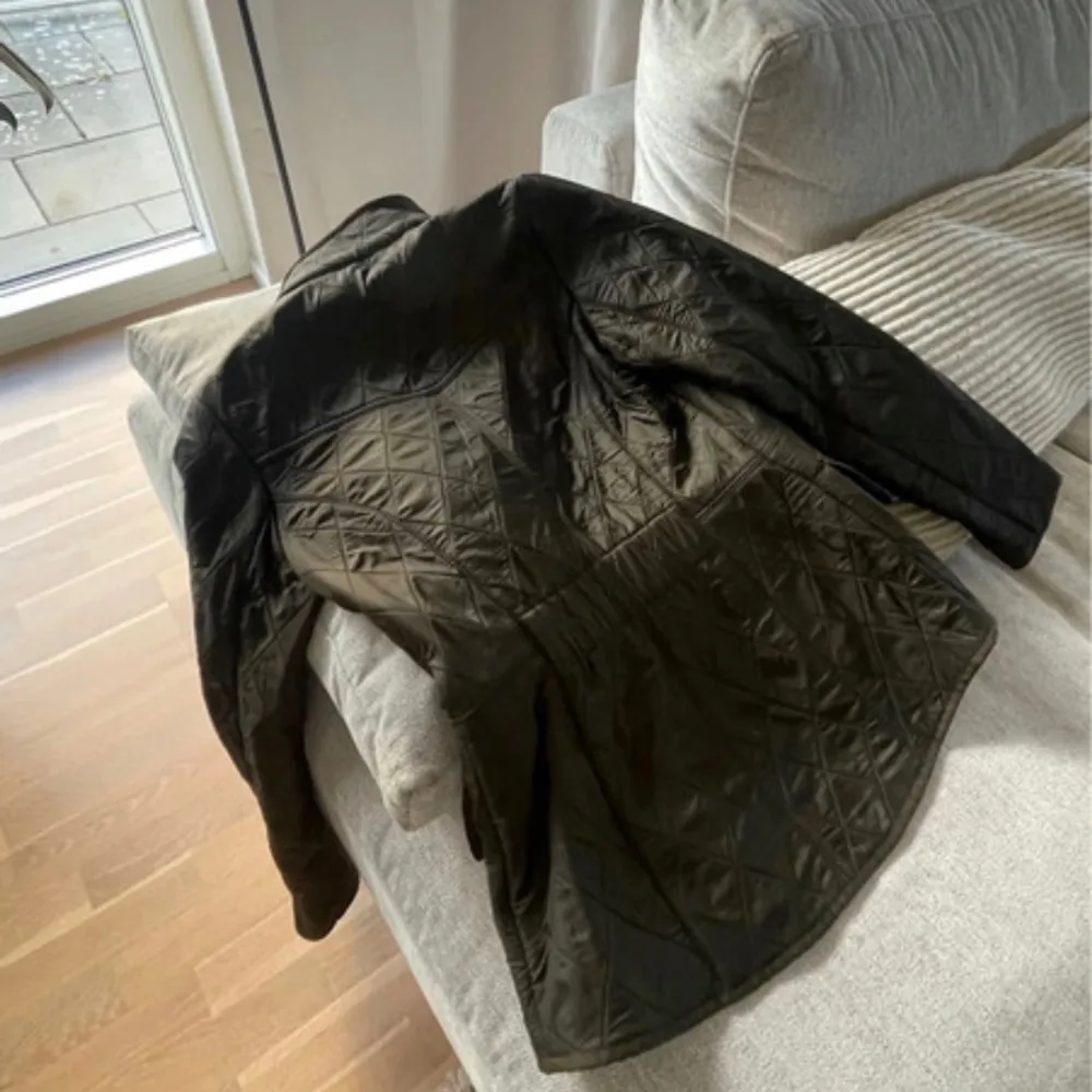 Första bilden är endast lånad och endast en liknande!!🥰Snygg militär grön quiltad jacka från Barbour med dragkedja och knappar. Jackan har en klassisk design med hög krage och praktiska fickor framtill. Perfekt för kyligare dagar.Helt ny med prislapp . Takit.