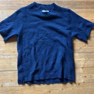 Marinblå stickat T-shirt tröja 👐🏻 - Säljer denna marinblåa stickade t shirt tröjan ! Ganska töjbar i storleken .. lite för stor för min smak därför säljer jag ☺️ fint skick! Kom dm för mer bilder 💙💙
