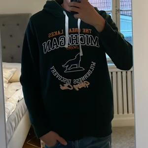 Mörkgrön hoodie från Brave Soul - Säljer en snygg mörkgrön hoodie från Brave Soul. Den har en cool text på framsidan och en klassisk känguruficka. Perfekt för höst och vinter när du vill hålla dig varm och bekväm. Passar både till vardags och chillkvällar. 🐻