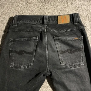 Svarta Nudie Jeans - Svart/gråa nudie jeans i perfekt skick! Storlek W29x32, skick 10/10, färg grå/svart, märke Nudie Jeans. Pris kan diskuteras vid snabb affär! 