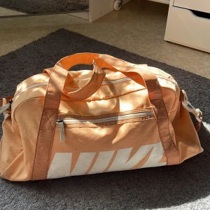 Nike peach färgad tränimgsväska - Säljer min Nike träningsväska. Lite smutsig på vissa ställen. Köpte för 500kr säljer för 100kr🥰
