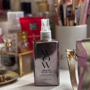 Dream Coat för lockigt hår -  Den är designad för att ge fukt och skydd till lockigt hår, vilket gör det mjukt och glansigt. Flaskan är stilren och silverfärgad med en praktisk spraypump för enkel applicering. har använt den en gång men mycket kvar liksom ny! 50ml