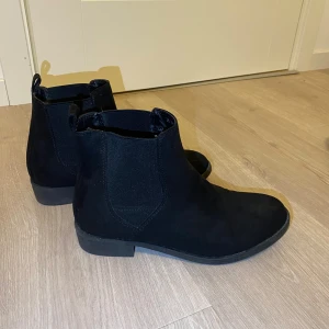 Boots - Svarta boots med liten klack som knappt är använda. Ser helt oanvända ut förutom slitningen längst fram på insidan av skorna (se sista bild) som kommit när man går och de stött vid varandra. 