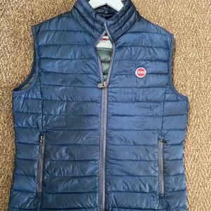 Colmar - Säljer nu min marinblå Colmar väst för 750kr och har ett nypris på ca 2800kr. Västen är i storlek 50 vilket motsvarar M/S. Den är i utmärkt skick och skulle bedöma den 9/10, perfekt inför våren!