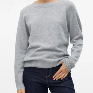 Grå stickad tröja från Vero Moda - Säljer en stilren grå stickad tröja från Vero Moda. Tröjan har en klassisk rund halsringning och långa ärmar med ribbade muddar. Perfekt för kyligare dagar. Tröjan är lite noppig men det är inget man tänker på💓