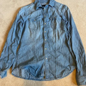 Blå jeansskjorta från Pepe Jeans - Säljer en blå jeansskjorta från Pepe Jeans i storlek M. Skjortan har långa ärmar och två bröstfickor med knappar 💞