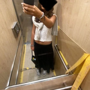 Svart lång-kjol från Gina Tricot - En svart låg kjol storlek S. Den e ganska lång men det går att vika ner den (jag är 171cm) och jag viker ned den.