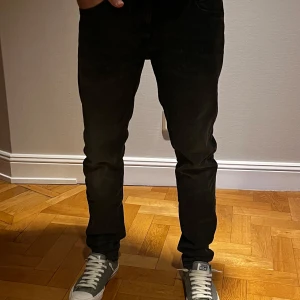 Svarta jeans från Lee - Snygga svarta jeans från Lee med en slim passform. De sitter riktigt bra och snyggt på dig som är runt 180 cm lång. De är iprincip oanvända så väldigt bra skick. Hör av dig vid minsta fråga eller fundering!