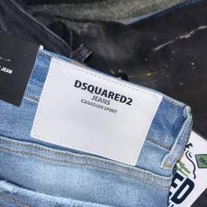 Jeans från Dsquared2 och Replay - Säljer två par jeans. Dsquared2 jeans i ljusblå tvätt med slitningar och färgstänk för en cool look. Replay jeans i mörkare blå med klassisk design och lätt slitna detaljer. Perfekta för både vardag och fest! Båda för 800