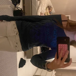 Mörkblå långärmad topp - Säljer en mörkblå långärmad topp med tryck framtill. Perfekt för en avslappnad stil. Passar bra till jeans eller kjol. Det står storlek L men passar tajt/bra på mig som bär XS så antar att det är barnstorlek!