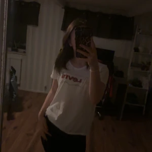 Vit t-shirt från Levi's - Säljer en klassisk vit t-shirt från Levi's med röd logga på bröstet. Perfekt för en avslappnad stil.