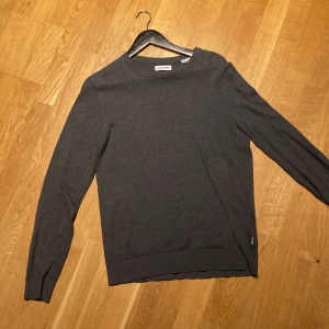 Mörkgrå crewneck i ull - Säljer en stilren mörkgrå tröja i materialet ull. Perfekt för både vardag och lite finare tillfällen. Säljer till ett riktigt bra pris. Storlek XS men passar även S